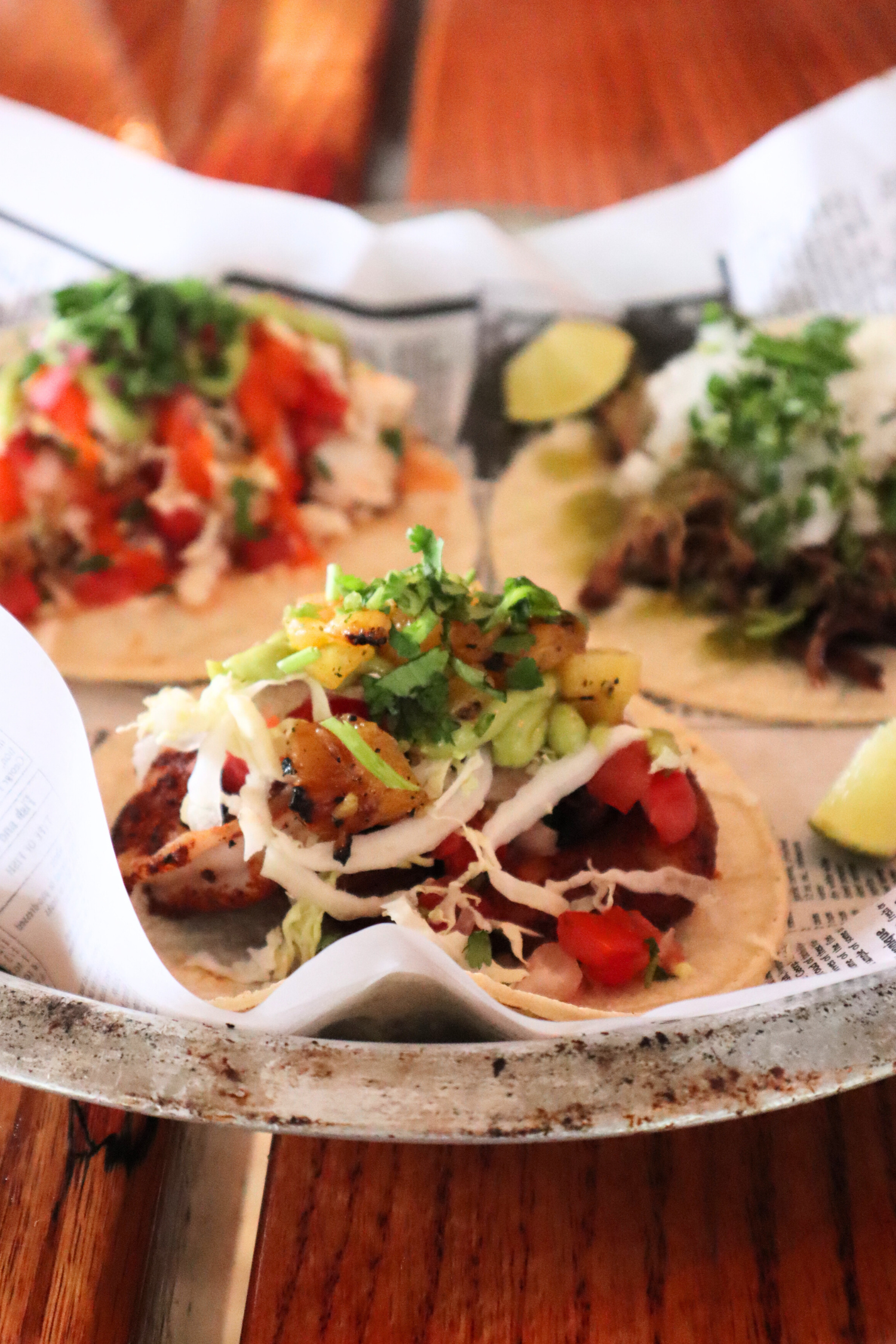 close up of three tacos on a tray
