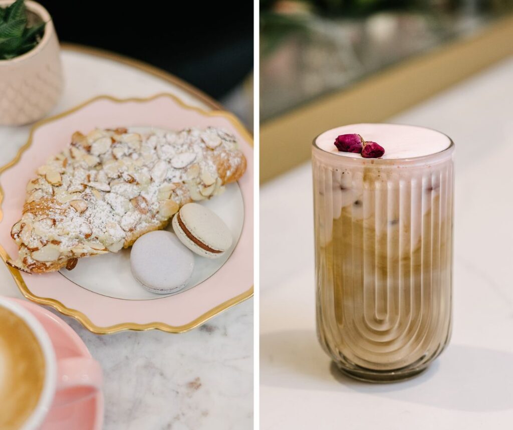 almond croissant and two macarons on a plate, image of a specialty coffee topped with flowers in a cool clear glass