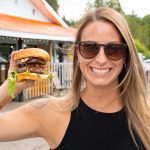 Nicole holding up the Eddy Burger in Thunder Bay