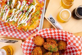 black bellows overhead shot of chicken wings, beer and tostadas