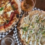 overhead shots of two pizzas, a beer and a g and t at Elgin Harvest