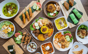 A wide shot if a table with a variety of different Thai food.