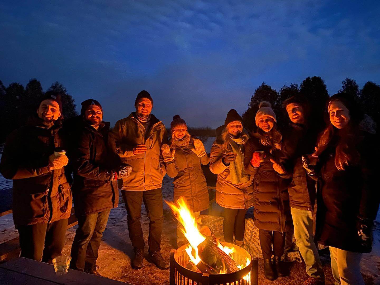 friends gathered around private fire pit at West Avenue Cider House