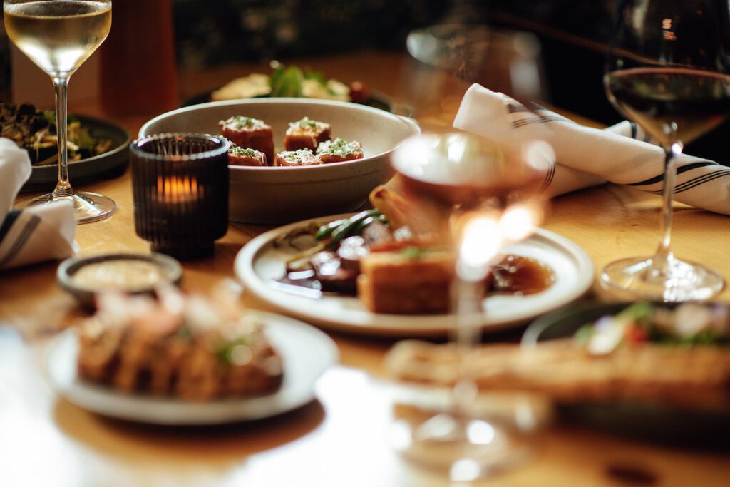 closeup of bruce wine bar dishes on the table and red wine