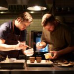 Two chefs plating with tweezers at Perch