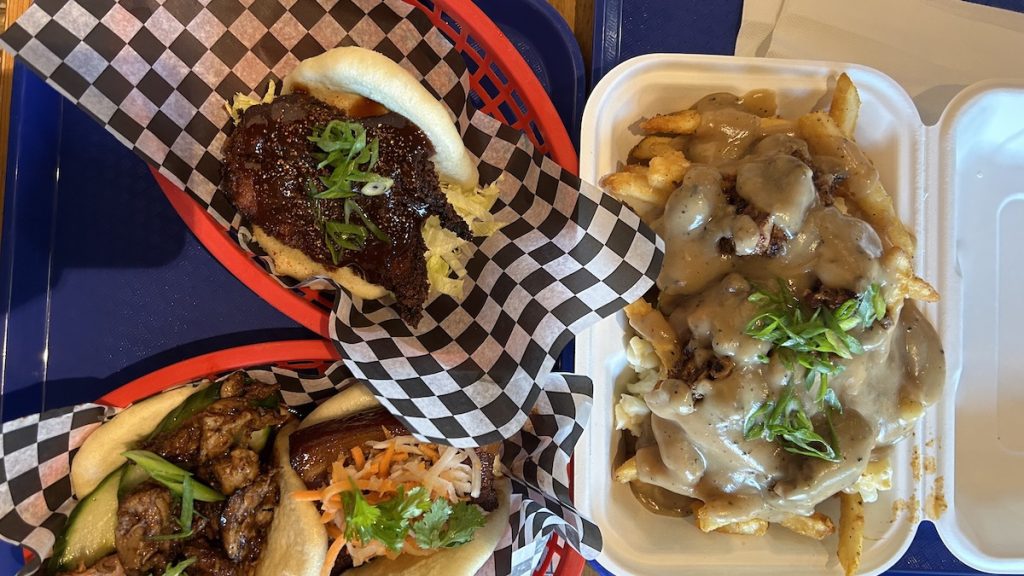 overhead shot of bao bar meal - bao buns and duck poutine
