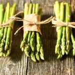 close up of three bunches of asparagus tied with twine