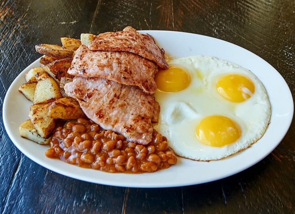 Plate with eggs, beans, potatoes, and bacon