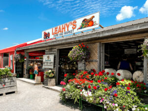 The front facae of Leahy's farm market on a sunny day with blue skies