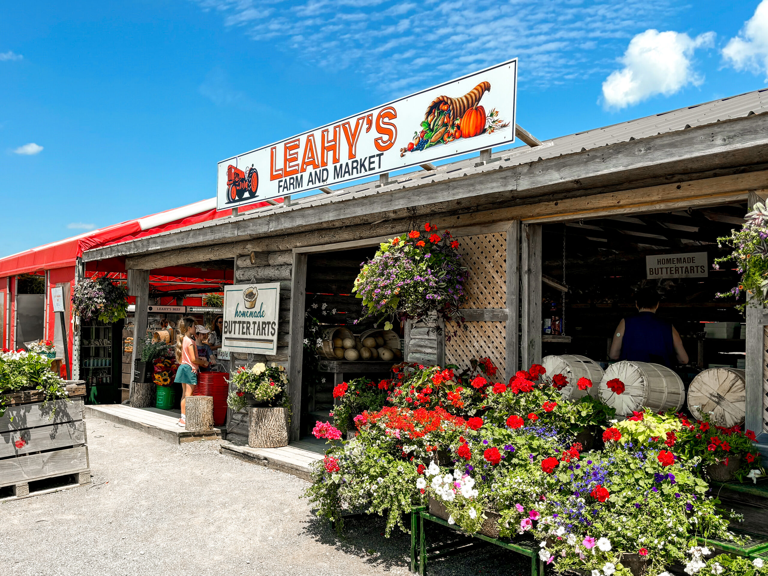 The front facae of Leahy's farm market on a sunny day with blue skies