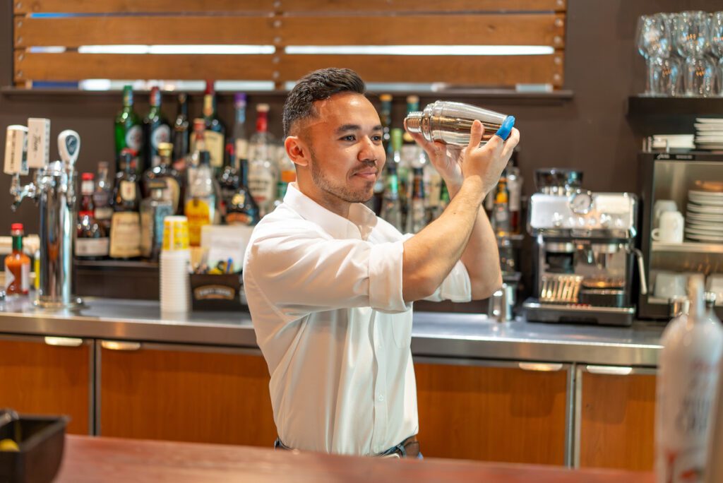 Bartender shaking a cocktail at Tomasso's