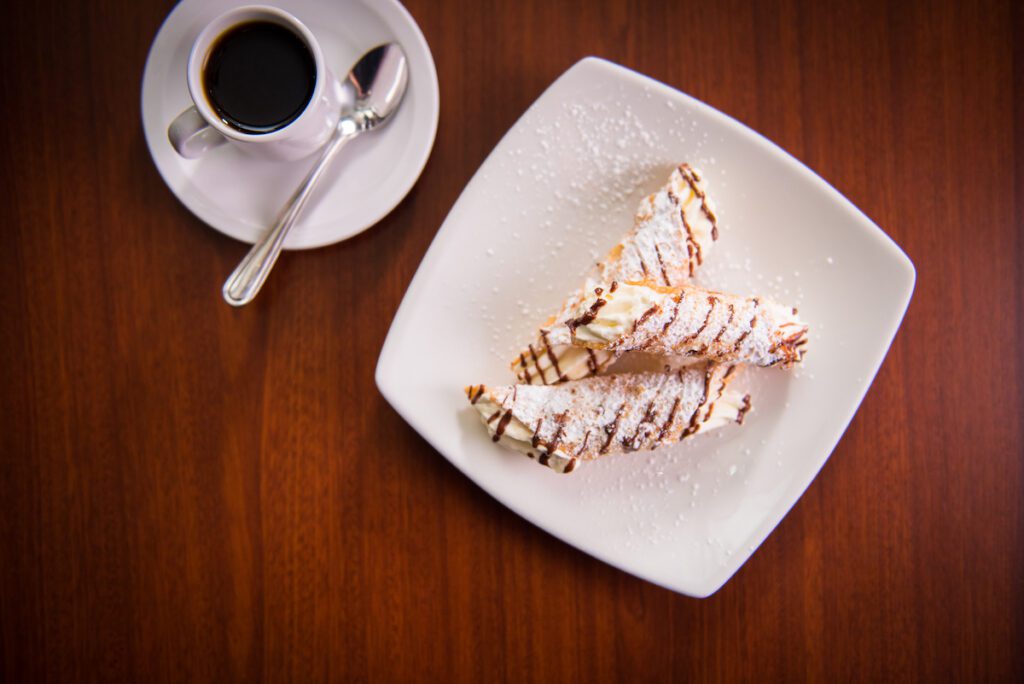 overhead shot of coffee and cannolis at Farina