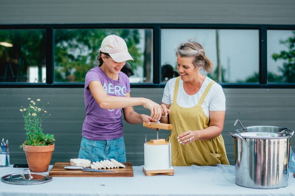 Two women making cheese at Jireh Hills
