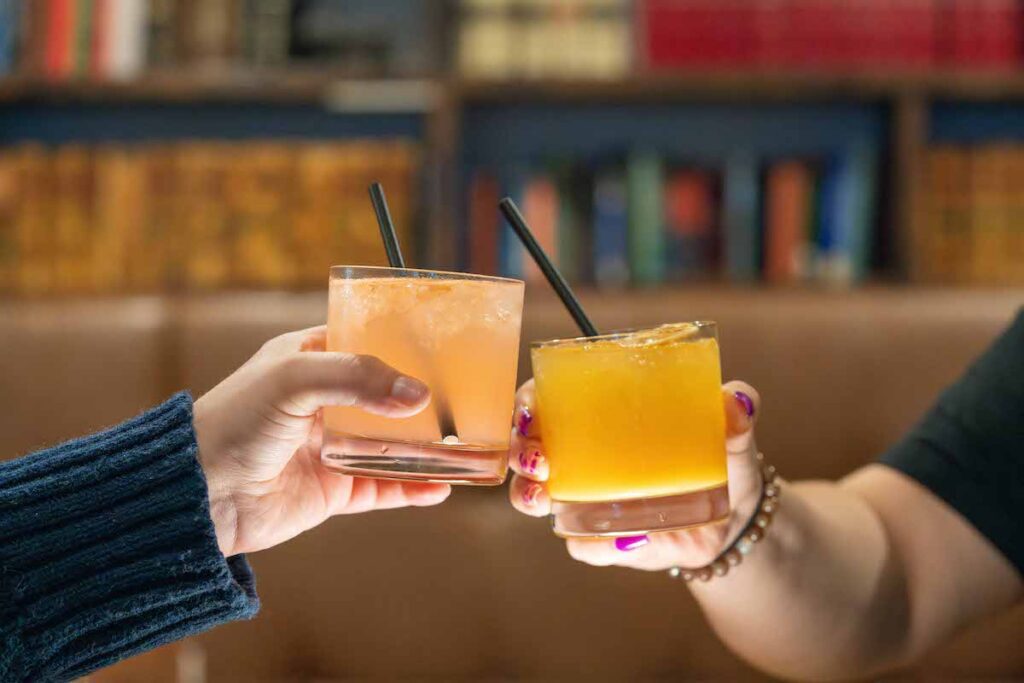 two cocktails cheersing at Arlington Hotel