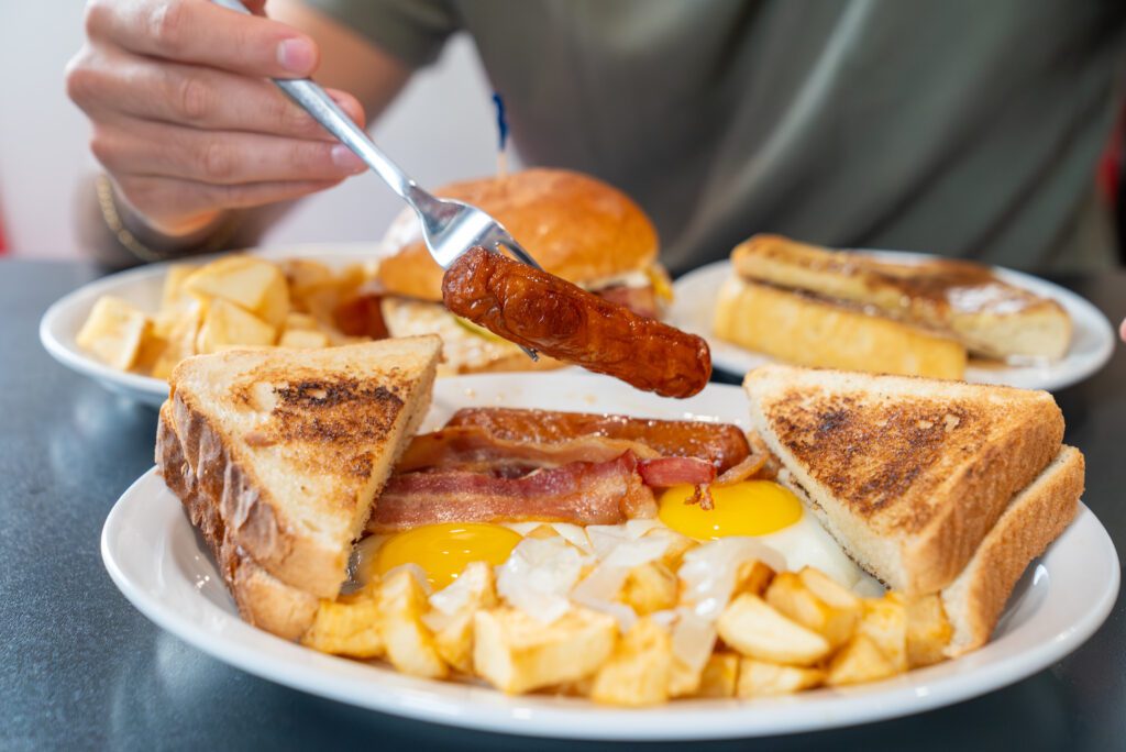 Cutting into eggs benedict at Syl's