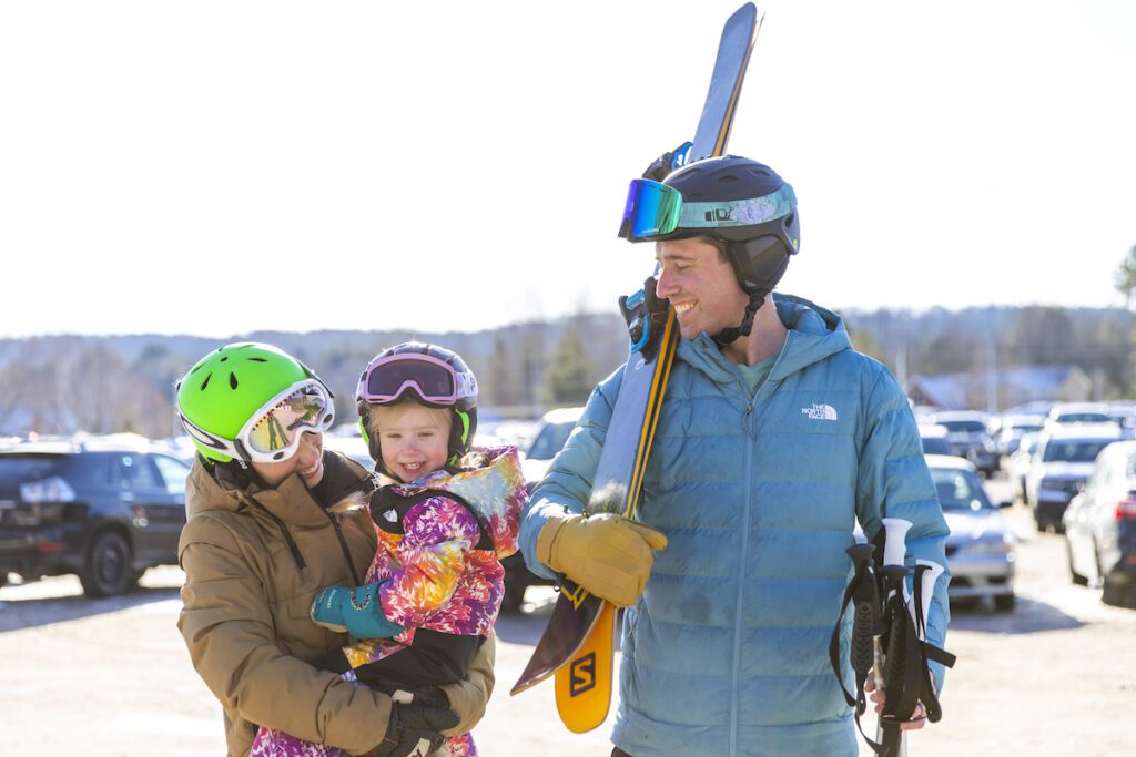 couple and their daughter geared up to ski at Mount St Louis in Moonstone