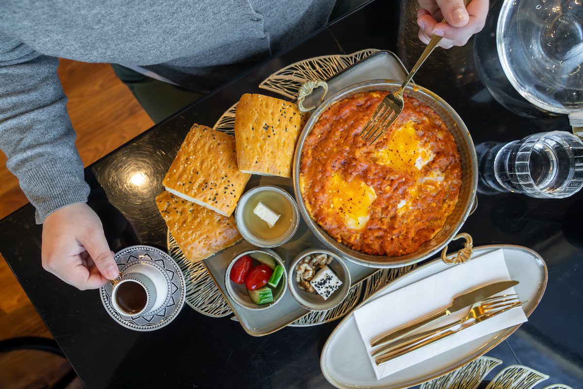 overhead shot of shakshuka, breads and more from Eldar Cafe