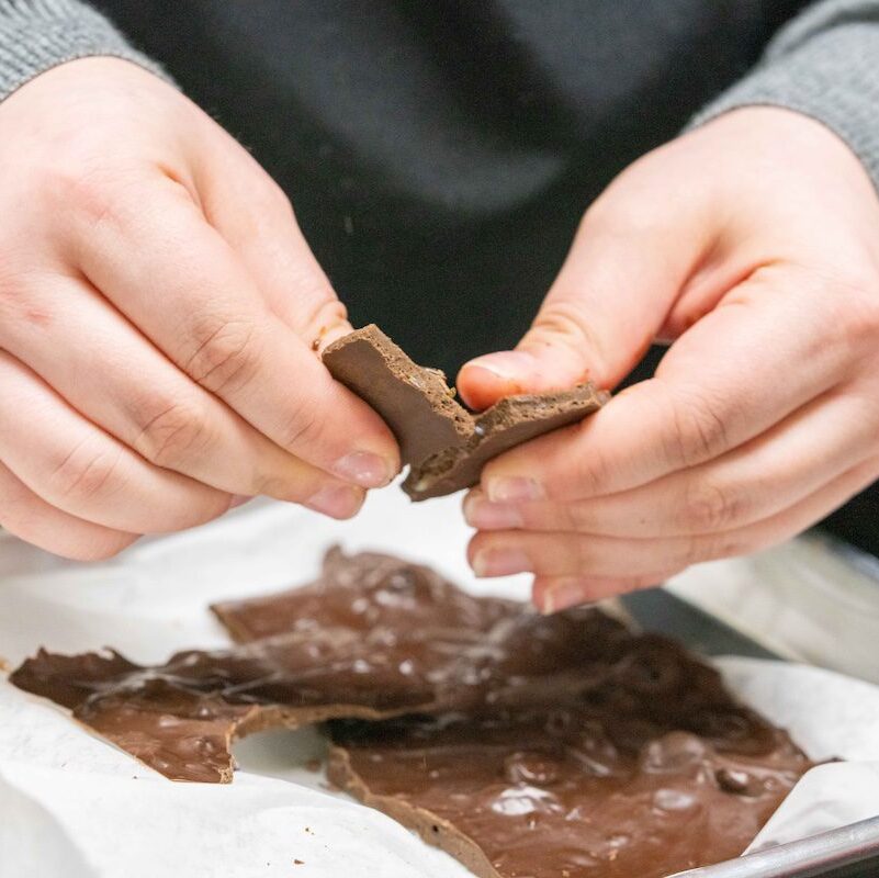 chocolate bark being snapped in half