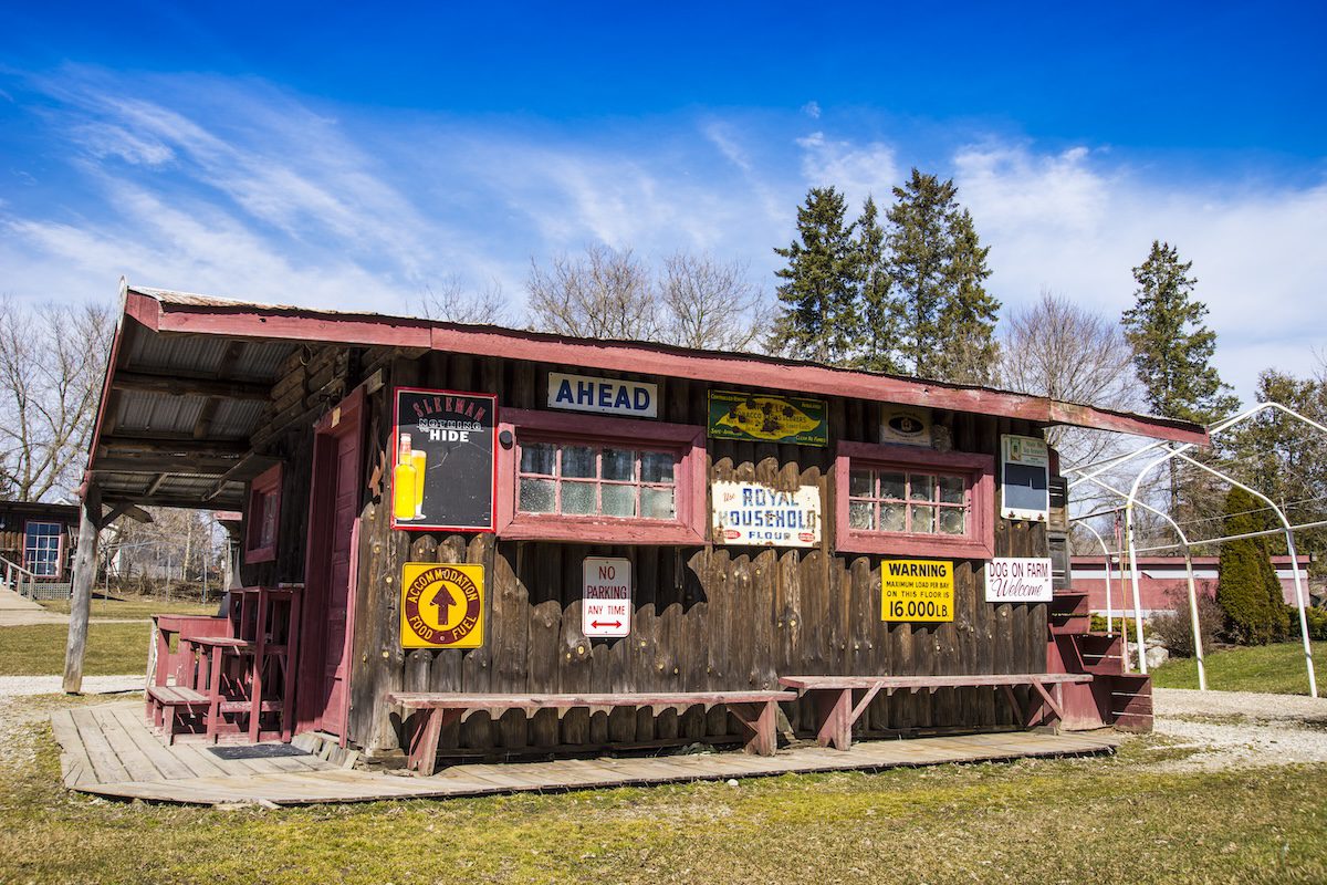 exterior of aberfoyle market, wooden bulding covered in antique signs
