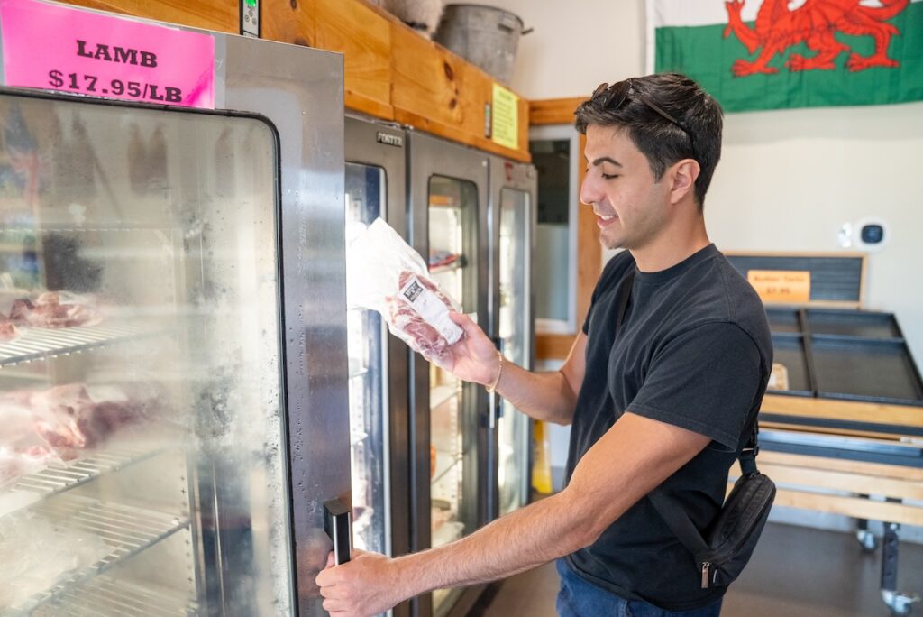 Zain looking at pepperttes from the fridge