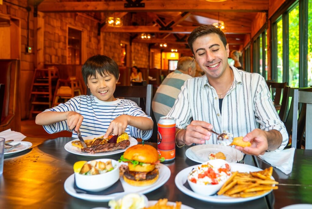 Child and adult eating dinner at the mill