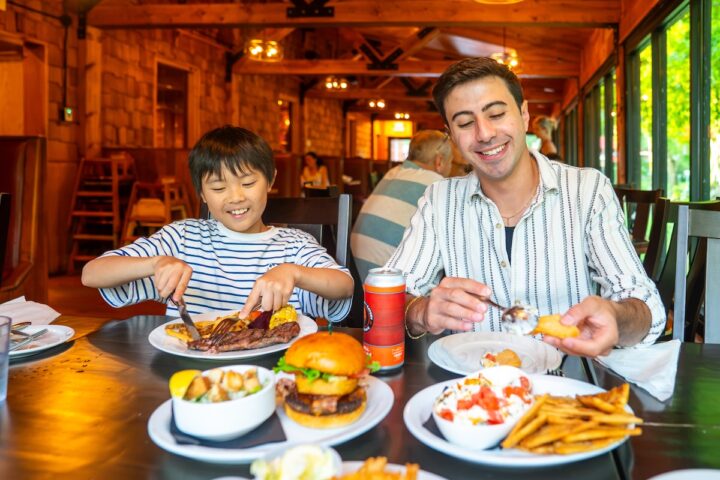 Child and adult eating dinner at the mill