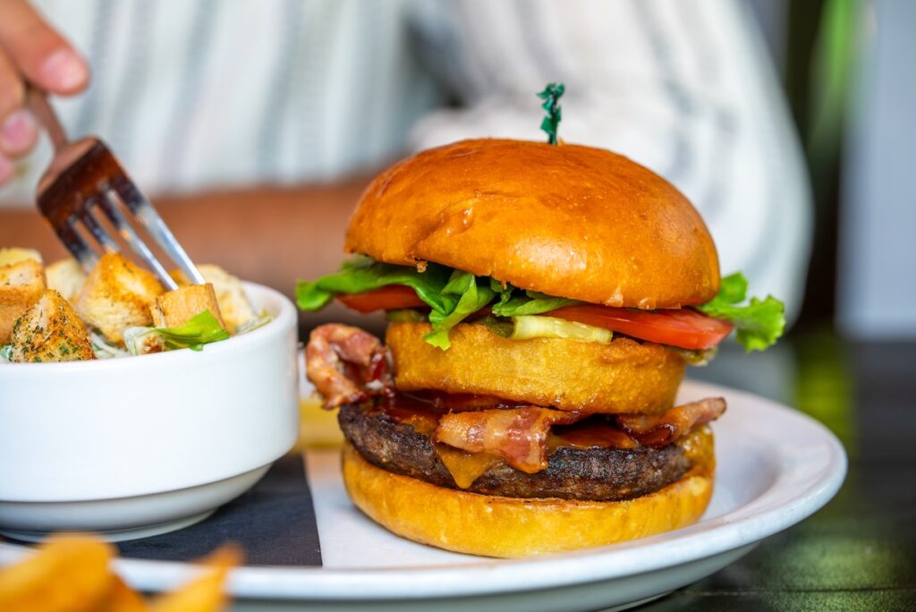 close up of burger with onion ring