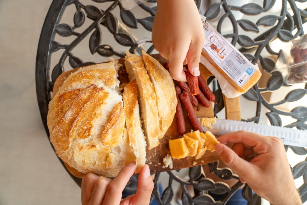 overhead shot of fresh bread, cheese and pepperettes